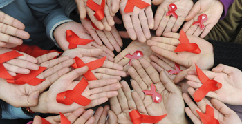 University students hold red ribbons at a photo opportunity during an HIV/AIDS awareness rally on World AIDS day in Chengdu
